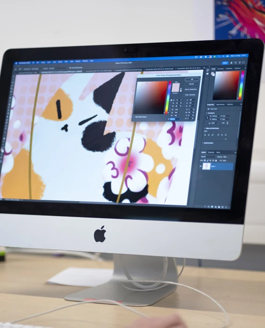 Close-up of a digital illustration being edited on an Apple iMac using graphic design software. Close-up of a digital illustration being edited on an Apple iMac using graphic design software.